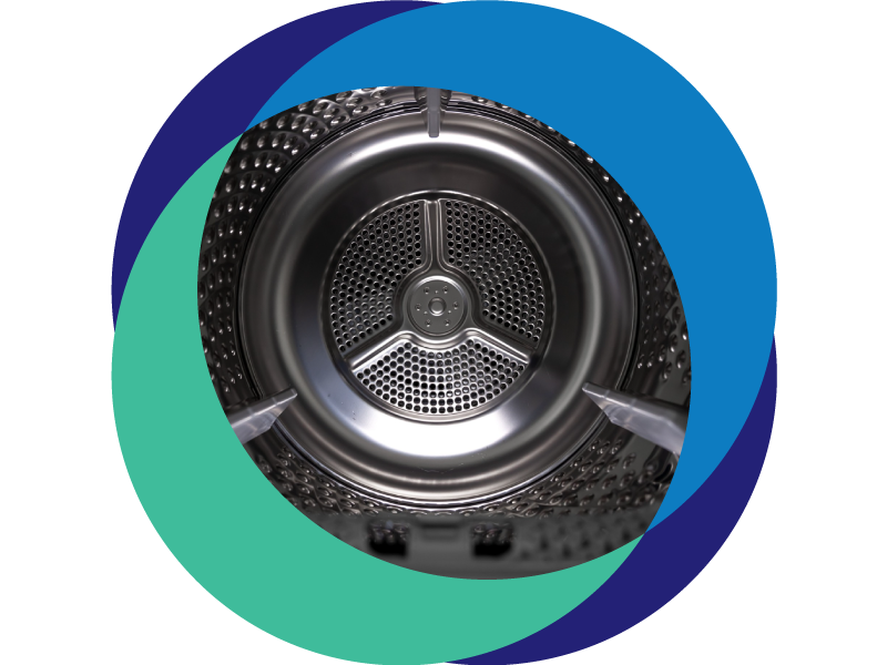 A close up of the interior of an industrial washing machine used for sustainable laundry solutions.